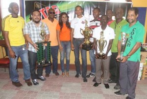 The top four EBFA clubs show off their trophies after receiving cash awards from Ansa McAl’s PRO Darshanie Yusuf (4th left) and Assistant Stag Beer Brand Manager Sean Abel (5th left). Also in photo are EBFA Secretary Franklin Wilson (3rd left) and President Wayne Francois (3rd right).