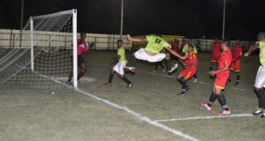 Ron Wilson (#11) of Cougars is airborne as he aims to head home this corner kick against Soesdyke but the ball was saved by goalkeeper Javier Greene (left).