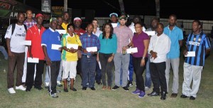 Ansa McAl PRO Ms. Darshanie Yussuf (centre front row) poses with representatives of the clubs after handing over the cheques at the #5 ground. Also in pic is Stag Beer Brand Manager John Maikoo who is at left of Yussuf.