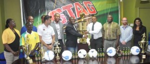Marketing Director of Ansa Mc Al Troy Cadogan (right) presents the first place trophy to secretary of the EBFA Franklin Wilson in the presence of officials of the other associations, Normalization Committee and sponsors. 