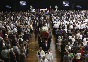The coffin of Hughes is carried down the aisle at Macksville High School. (EPA)