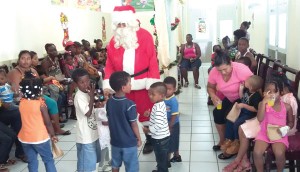 The children, their parents, guardians, Santa and other helpers having fun 