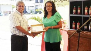 DDL CEO Mr. Samaroo presenting Mrs. Bhulai with her Award