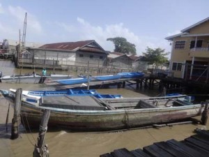 three of the small size boats sit on the ramp 