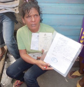 Ashmoon Khan displays her husband’s fishing licence while insisting that he was murdered  