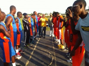 Banks DIH Berbice Branch, Sales Manager Joshua Torrezao (centre) chats with the teams prior to the start of the action.