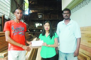 Marketing Manager at The Builders Lumber Yard, Shivani  Salim  (second, right) hands over the sponsorship cheque to Lionel  D’Andrade yesterday while a staff also shares the moment.