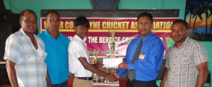 Jaggai Memorial: Mr. Steven Seeraj, son of the late Parbattie Jaggai hands over the sponsorship cheque to UCCA treasurer Mr. Vicky Bharosay. Also in photo are other executives of the UCCA.