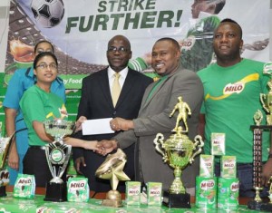 Nestle Milo representative Renita Sital hands over the sponsorship cheque to Petra Organisation Co-Director Troy Mendonca in the presence of Chief Education Officer Olato Sam (centre), Petra Organisation Angeline McCarthy (left) and Referee Wayne Griffith.
