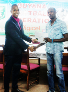 Normalisation Committee Chairman Clinton Urling hands over certificate of appreciation to Abdulla Hamid.  