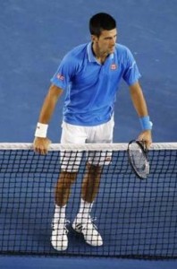 Novak Djokovic of Serbia leans on the net after defeating Milos Raonic of Canada in their men’s singles quarter-final match at the Australian Open 2015 tennis tournament in Melbourne January 28, 2015.  REUTERS-Carlos Barria