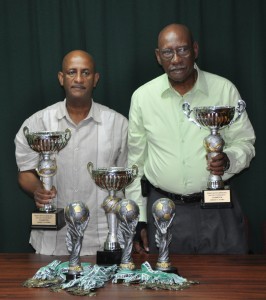 President of Pele FC John Yates (right) and Club Secretary Mark Archer pose with the trophies and medals up for grabs during the two tournaments. 