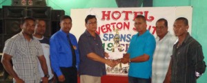   Proprietor of Hotel Riverton Suites Dr. Pooran Seepersaud hands over the sponsorship cheque to UCCA President Mr. Dennis De Andrade. Also in photo are other executives of the UCCA.