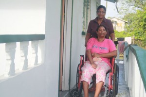 Injured Roxanne  Winfield and her  sister Jacqueline  outside her new  house yesterday. 