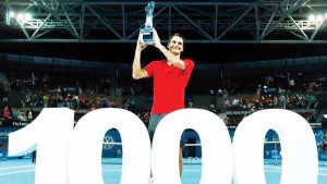 Roger Federer of Switzerland poses with a giant number 1,000 after winning his thousandth career title in the men’s singles final at the Brisbane International tennis tournament in Brisbane, January 11, 2015.