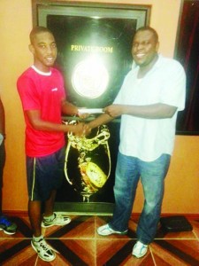 Shemar Britton (left) receives his reward from SVT Manager Dillon Griffith.