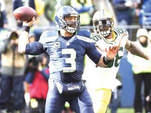 Seattle Seahawks quarterback Russell Wilson (3) throws under pressure from Green Bay Packers defensive end Mike Neal (96).  Photo by Kyle Terada, USA TODAY Sports