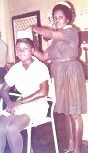 Young Nurse Munroe receives her cap from Sr. Gwendolyn Albert at Fort Canje