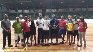GTTA President, Godfrey Munroe (left) poses with the various prize winners from their Open Table Tennis tournament Sunday at the Cliff Anderson Sports Hall.