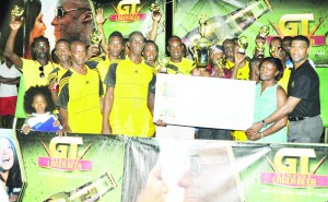 Banks DIH Brand Manager Errol Nelson (right) and Linden Branch Manager Shondell  Nelson (2nd right) presents the winning cheque to Winners Connection Captain in the presence of  teammates following their win in the final over Hi Star on New Year’s Day.