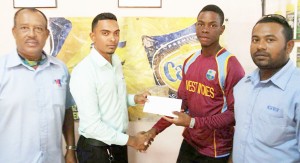 Shimron Hetmyer, West Indies U-19 and Senior National Opener, collects sponsorship cheque from Tajeram Khemraj in the presence of Hubern Evans (left) and Ishwar Singh.