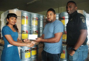Sales Representative at Yellow Mine Hydraulic Supplies, Vanie Ramnauth (right) hands over the sponsorship cheque to NEE Directors, Kenrick Noel and Aubrey Major Jr. yesterday.