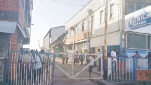 Workers milling around  GNIC's shipyard minutes after the robbery.