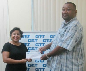 GT&T Marketing Senior Officer Ms. Anji Hackett hands over the cheque to RHTY&SC’s Hilbert Foster. 