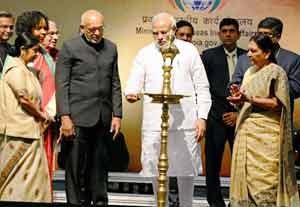 Indian Prime Minister, Narendra Modi, lights the lamp as President Donald Ramotar, External Affairs Minister Sushma Swaraj and Gujarat CM Anandiben Patel look on during the 13th edition of ‘Pravasi Bharatiya Divas’ in Gandhinagar. (Photo PTI)