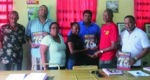 RHTY&SC Assistant Secretary Plaffina Millington hands over a copy of the Magazine to Albert Smith of the BCB.