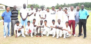 Members of the victorious Berbice team display their hardware along side officials of the GCB.