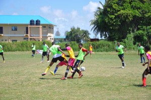  Bishop’s High vs. East Ruimveldt: Caption- Players from both Bishop’s High and East Ruimveldt fight for possession of the ball in their clash yesterday at the Ministry of Education ground.
