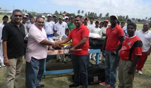 GCB President, Drubahadur, hands over kit to Christopher Singh from Lusignan. Also in photo are Jitlall Jowharilall from Enterprise (1st from right), Delbert Hicks, from Rosehall Youth and Sport Club (2nd from right) and GCB Secretary, Anand Sanasie (1st from left).