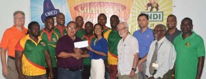 Marketing Director Anjuli Beharry-Strand (centre) hands over a cheque worth US$10,000 to Union President Peter Green in the presence of officials and national players in the Boardroom of the sponsor yesterday.