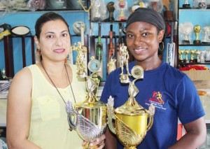 Mrs Devi Sunich (left) & Mrs Noshavyah King, pose with the winning male & female trophies, at the Trophy Stall South Rd Branch.