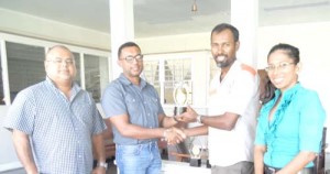 In Photo, (From left) Mr. Eric Doobay presents a trophy to Mr. Raymond Islam, while Mr. Ryan McKinnon and Ms. Vidushi Persaud share the moment.