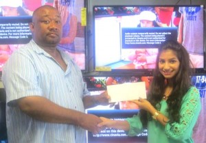 Ms. Davya Sievdatsan hands over the cheque to Hilbert Foster.