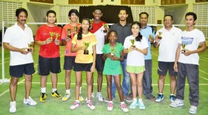 The respective top finishers in the GUMDAC sponsored Badminton tournament display their prizes after the presentation along with officials.