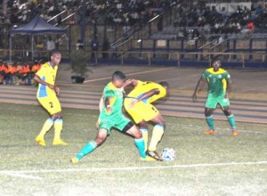 On debut, Golden Jaguar Emery Welshman (2nd left) battles for position in Barbados’ final third on February 1 in the Land of the Flying Fish. The Game ended 2-2. 