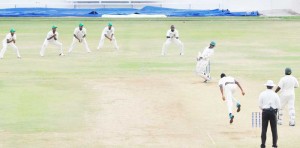 Jaguars on the attack! Horace Miller evades a bouncer from Ronsford Beaton.
