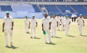 Keon Joseph who took 3-34 to lead Jamaica’s demolition, takes his Guyana cap off as he leaves the field following the Jaguars’ win at Sabina Park yesterday.