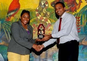 One of last year’s participants as she accepted an award from Minister of Culture, Youth and Sport Frank Anthony.