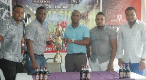 Mackeson Brand Coordinator, Jamaal Douglas (third, right) and Aubrey Major Jr. pose with the title trophy to usher in the second edition of the NEE Mash Futsal Tournament; from left to right are NEE Directors, Shareef Major, Kenrick Noel and Winston Fraser.