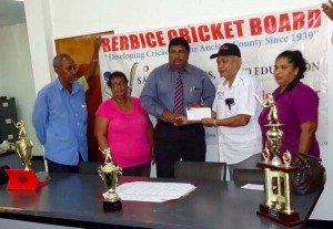 Mr Deonarine Rambharose hands over sponsorship to Anil Beharry, President of the Berbice Cricket Board in the presence of Angela Haniff and Carl Moore.