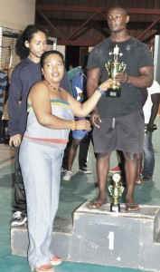 Wife of GAPF President Peter Green, Shellon, presents the Junior Overall trophy to Rudolph Blackman.  