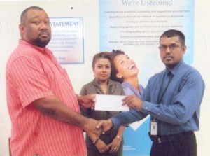 RHT Republic Bank Manager Harry Das Ghaness hands over cheque to RHTYSC Secretary/CEO Hilbert Foster.