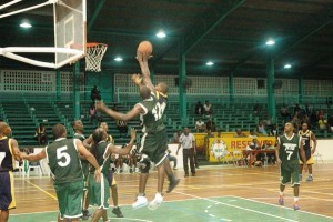 Jets’ forward, Alister Webster (#12) challenges Guardians’ guard, Ron Campbell’s floater in the paint Sunday night at the Cliff Anderson Sports Hall.