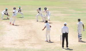 Shemron Hetymer (silly mid-off) takes evasive action as Odean Browne goes after Devendra Bishoo. Jason Dawes who shared a record last wicket stand with him, watch from the non strikers’ end.