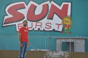 Guyana and regional Superbike king Stephen ‘Valentino Rossi’ Vieira poses in front ofhis sponsor Sunburst Orange Juice sign yesterday. 