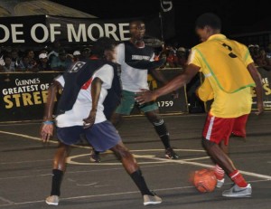 caption- Action in the clash between West Side Ballers and Raiders which the former won.